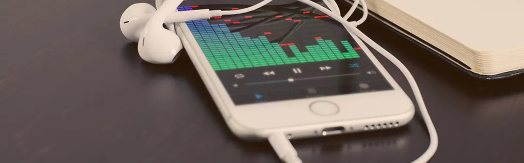 white phone with bar graph and earbuds