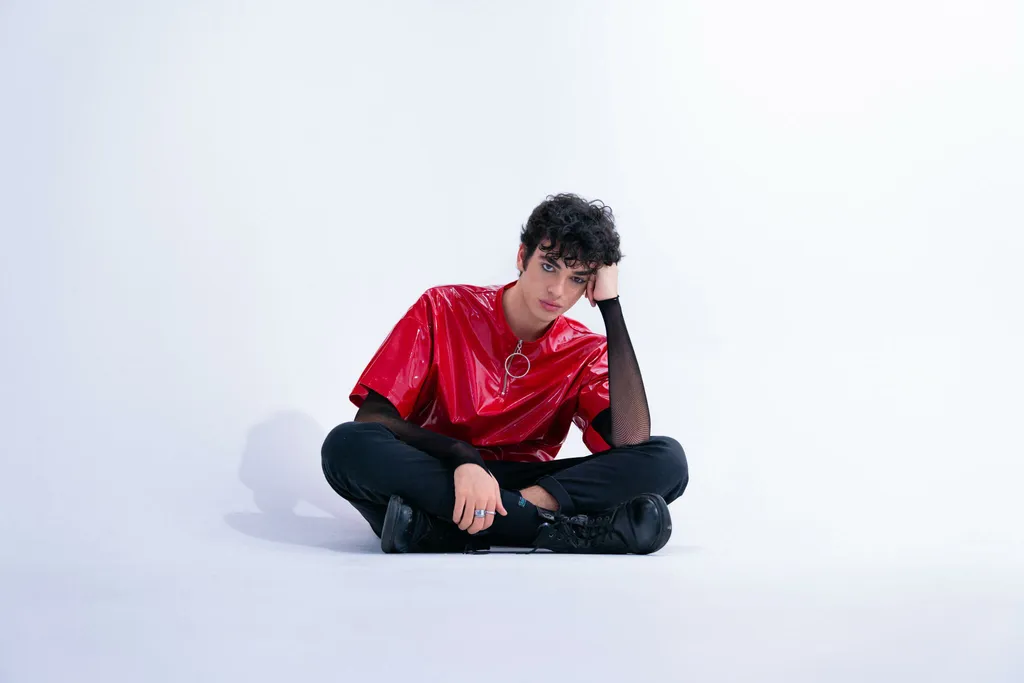 white background with men sitting with red t-shirt