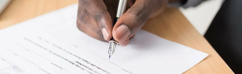 Hand signing a contract