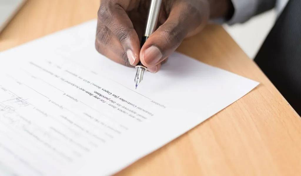 Hand signing a contract