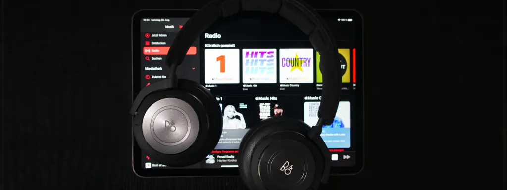 Black headphones in front of a music streaming screen