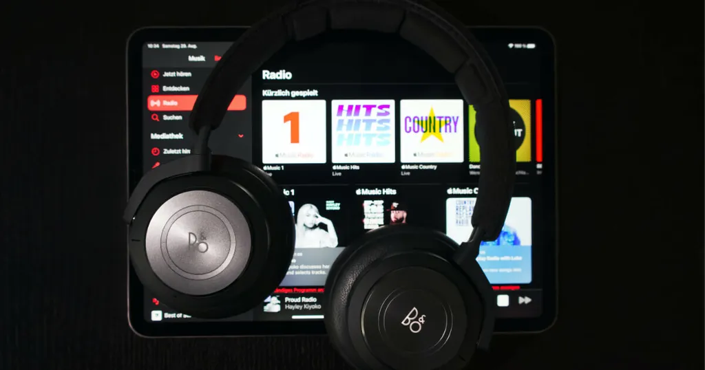 Black headphones in front of a music streaming screen