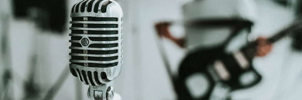 Microphone with guitarist in the background
