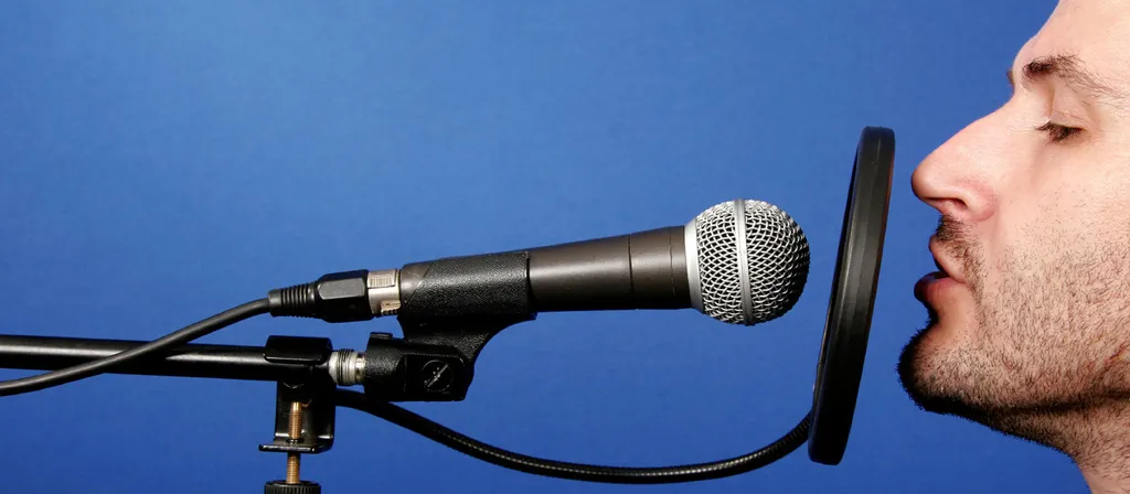 Man Sining Into A Microphone