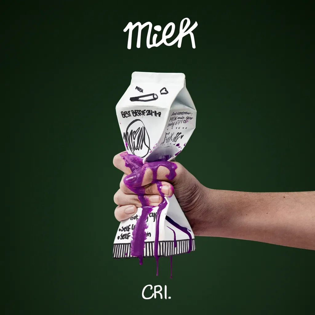 green background with box of milk being pressed by hand