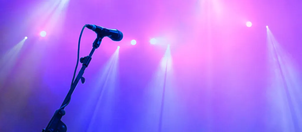 microphone on stage with purple lighting